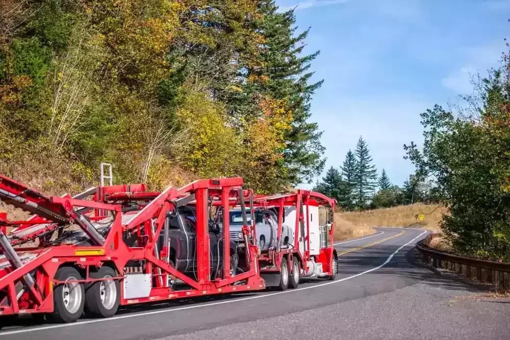 a red truck going through a narrow road
