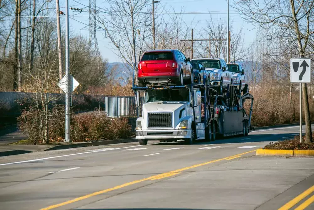 semi trailers loaded with different vehicles