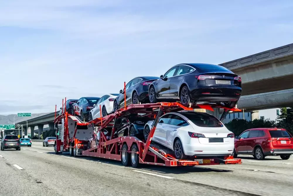 a truck carrying eight vehicles
