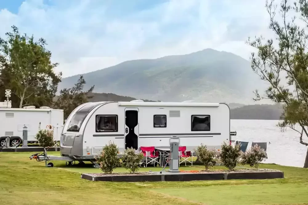 lovely caravan park set by a lake with trees