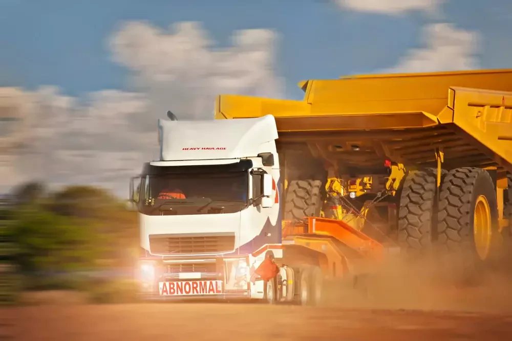 a truck carrying a big machine