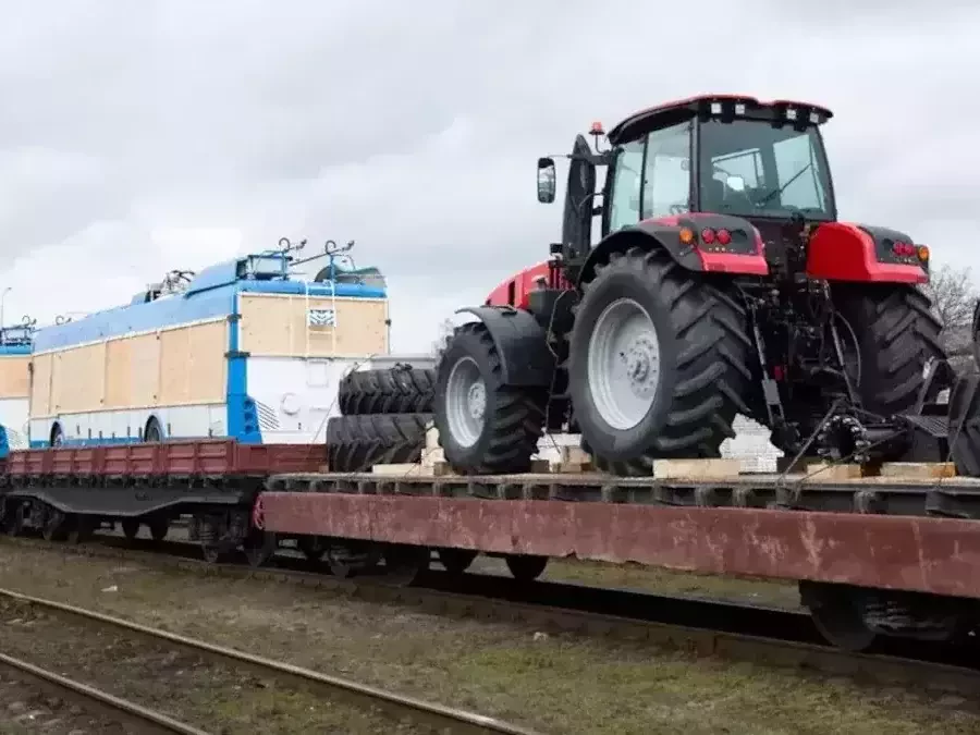 train transporting a tractor and trailer