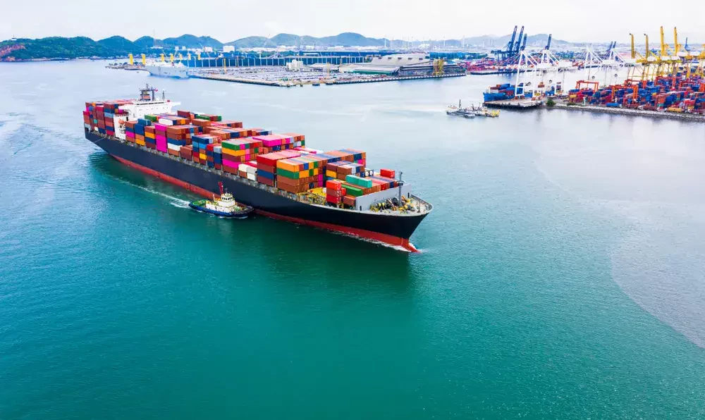 a large container vessel nearby a port