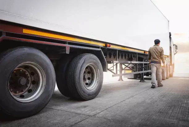 a man stands by a truck