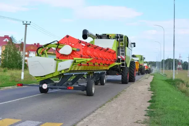 agriculture machine with trailer beside the road