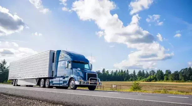 a semi truck transporting a vehicle