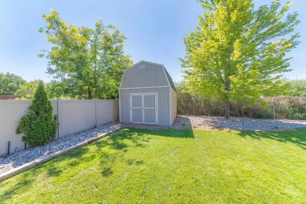 backyard scene showcasing a shed and a fence
