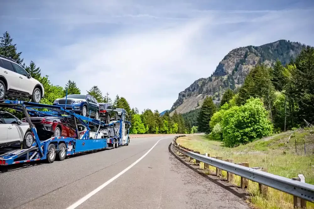 a truck on a road surrounded by small mountains