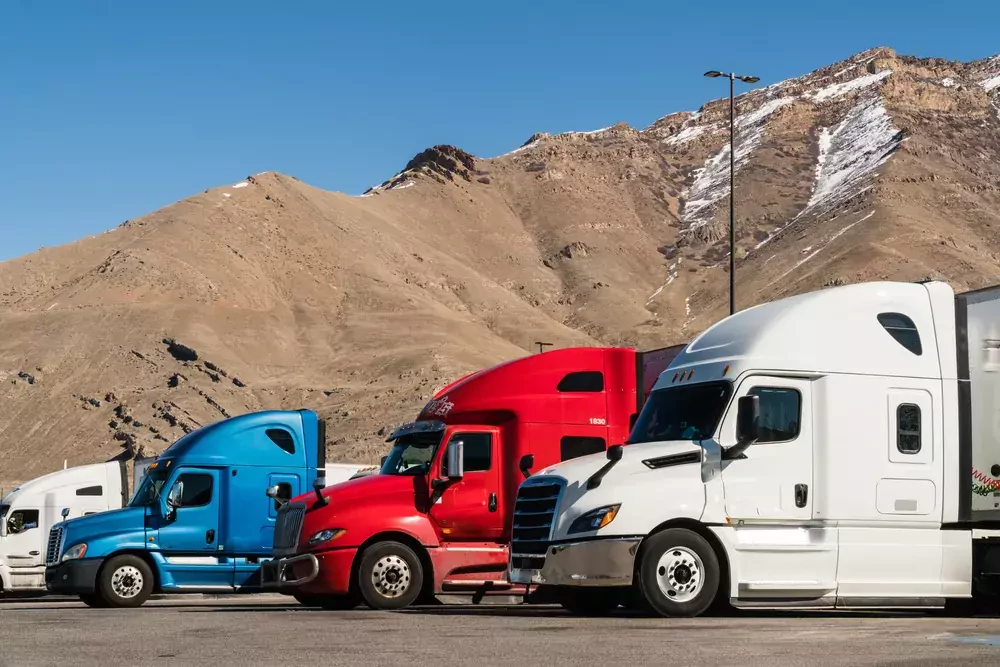 trucks parked in front of a hill