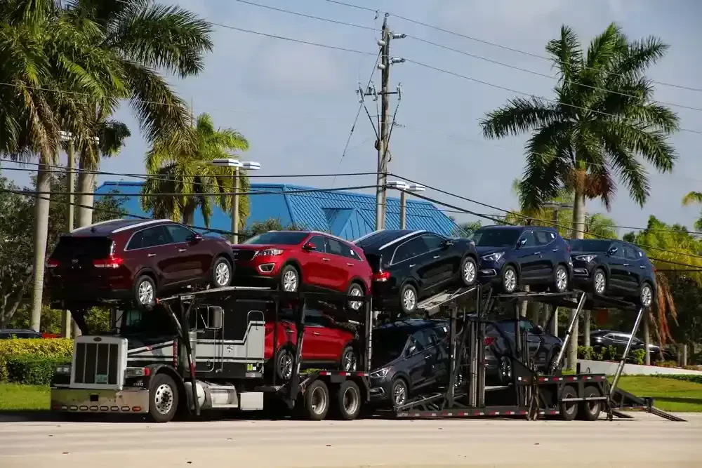 truck carrying eight vehicles