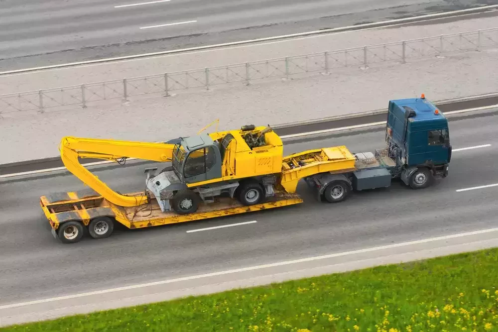 heavy equipment transporting by truck