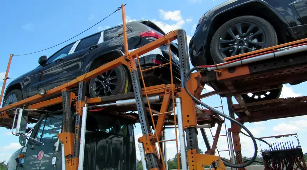 truck transporting a vehicle on its flatbed