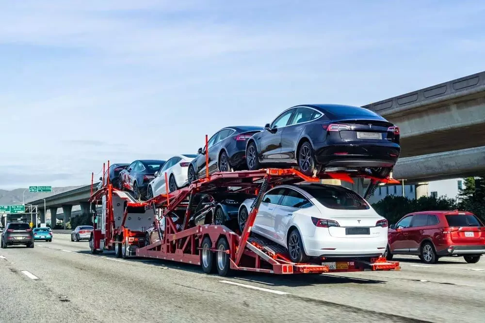 a truck carrying eight vehicles