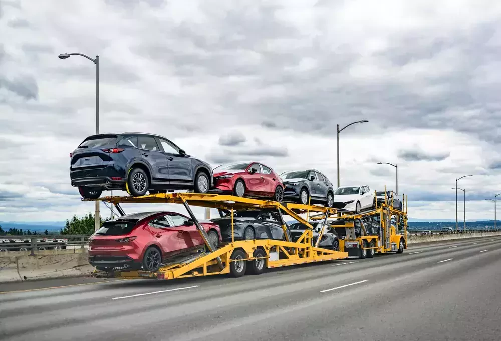 group of vehicles loaded on a trailer