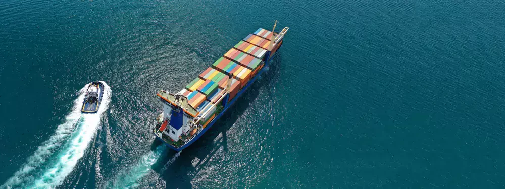 a boat and a large vessel nearby